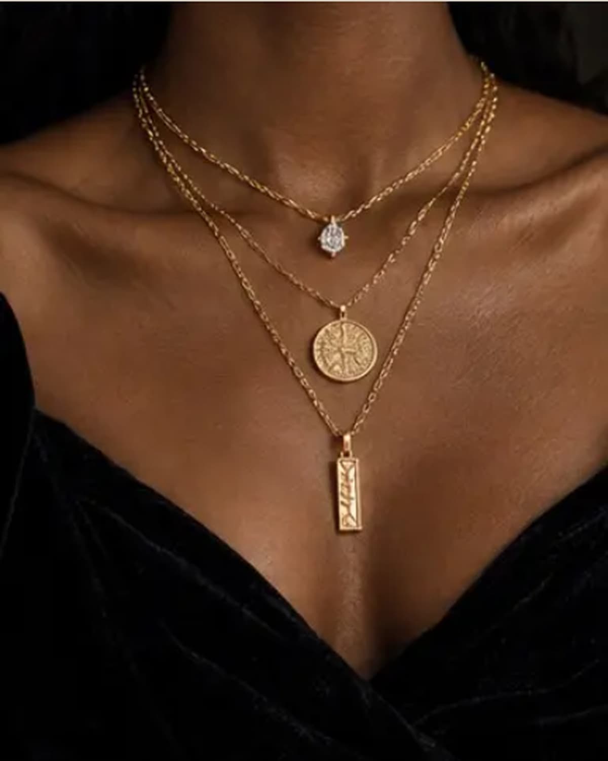 Gold curb chain necklace, worn at the collarbone