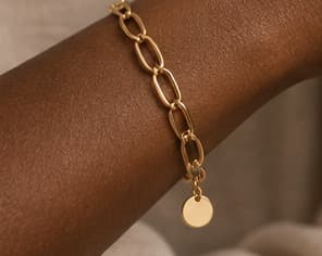 Gold link chain bracelet, worn on the wrist